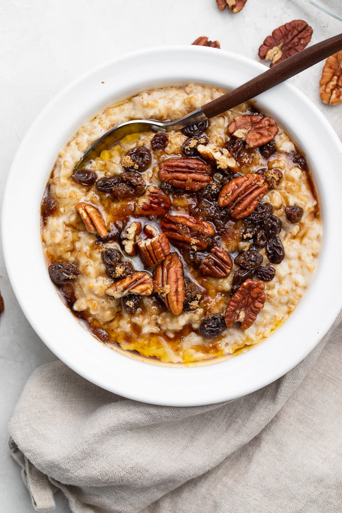 A bowl of Instant Pot steel cut oats topped with pecans and raisins.