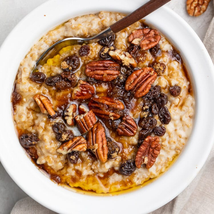 A bowl of Instant Pot steel cut oats topped with pecans and raisins.