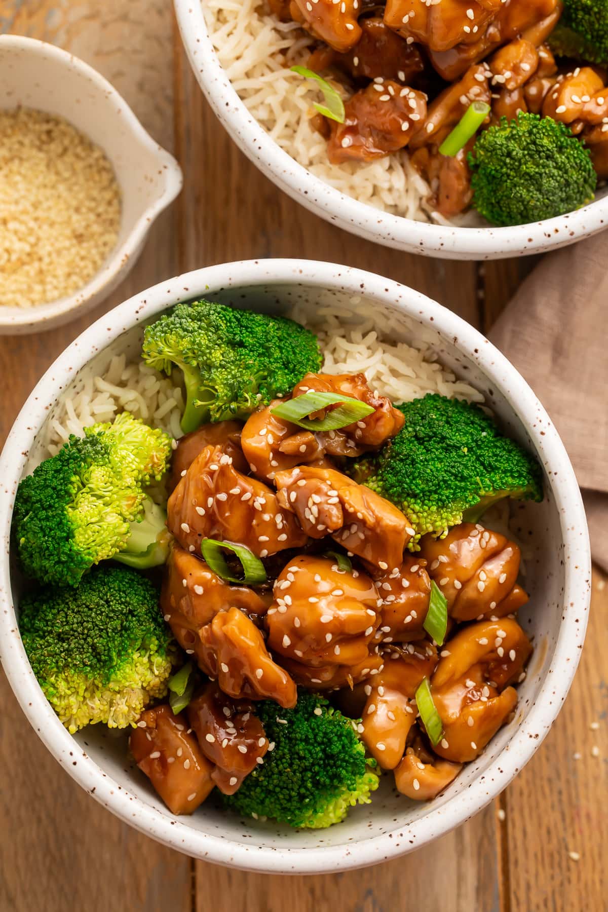 Overhead look at a white bowl holding Instant Pot chicken teriyaki with bright green broccoli and steamed white rice.