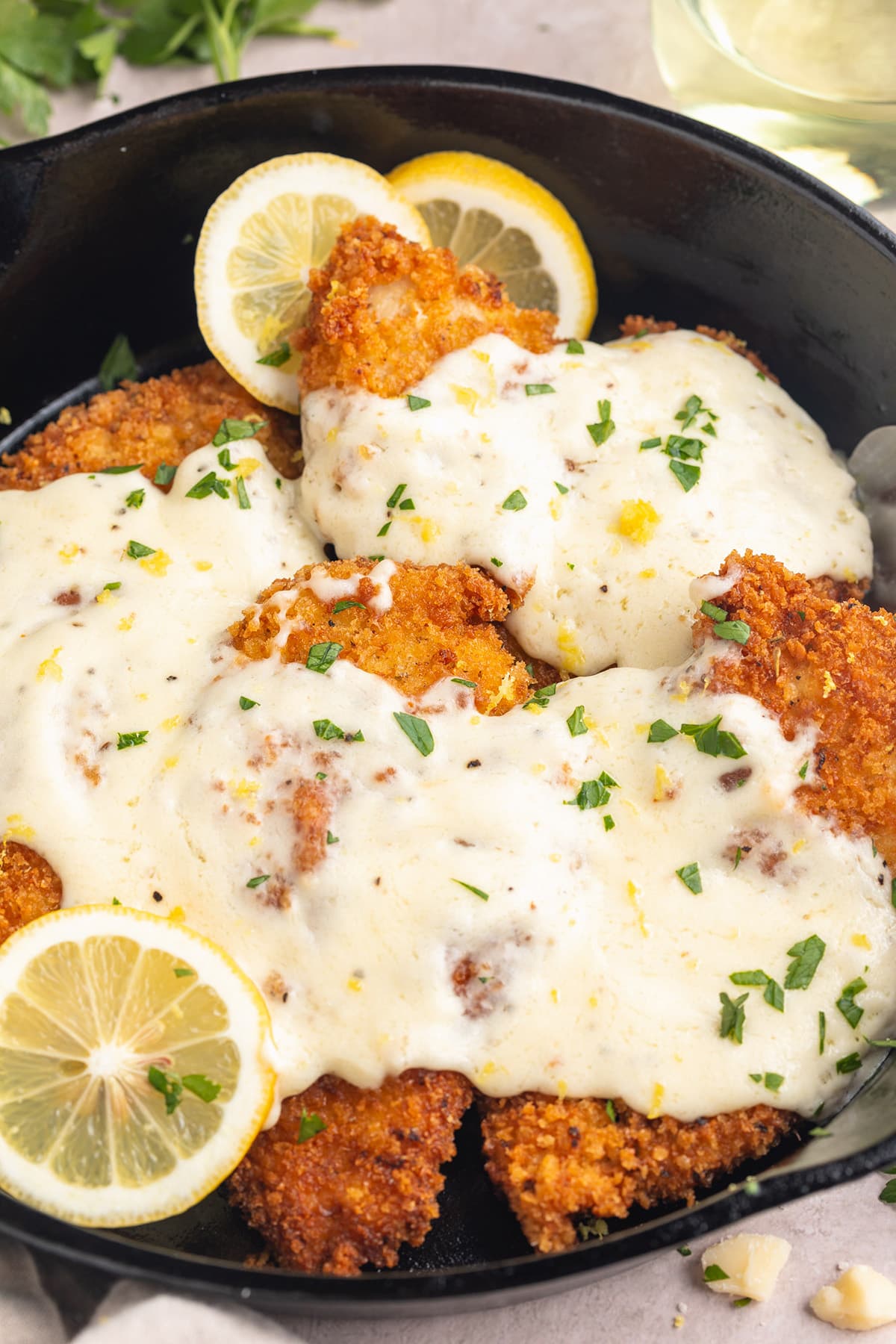 Cheesy chicken romano in a large cast-iron skillet.