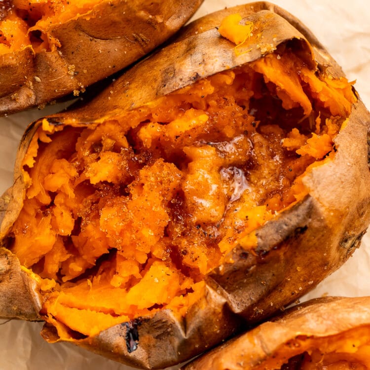 Close-up of a split sweet potato cooked in a Crockpot, topped with butter and cinnamon.