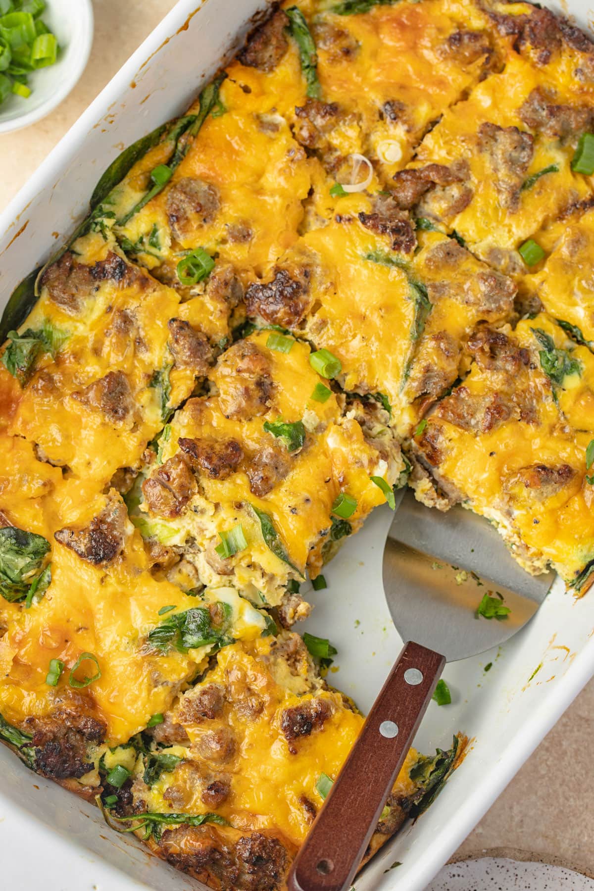 Overhead view of a keto sausage, egg, and cheese breakfast casserole in a casserole dish.