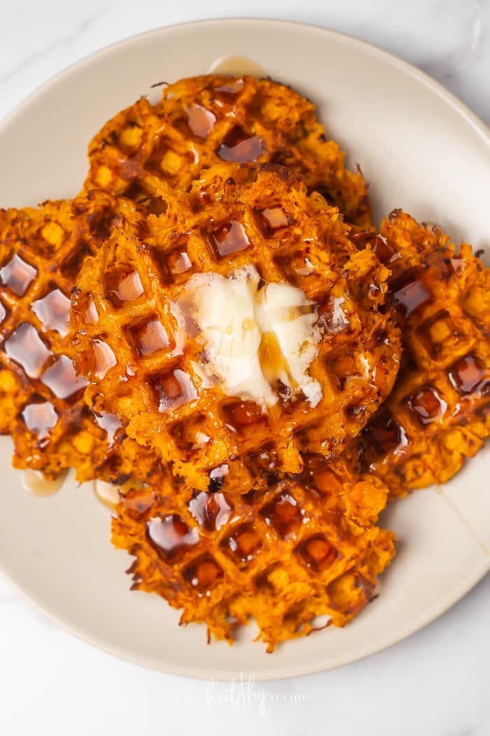Sweet Potato Waffles topped with butter on a plate.