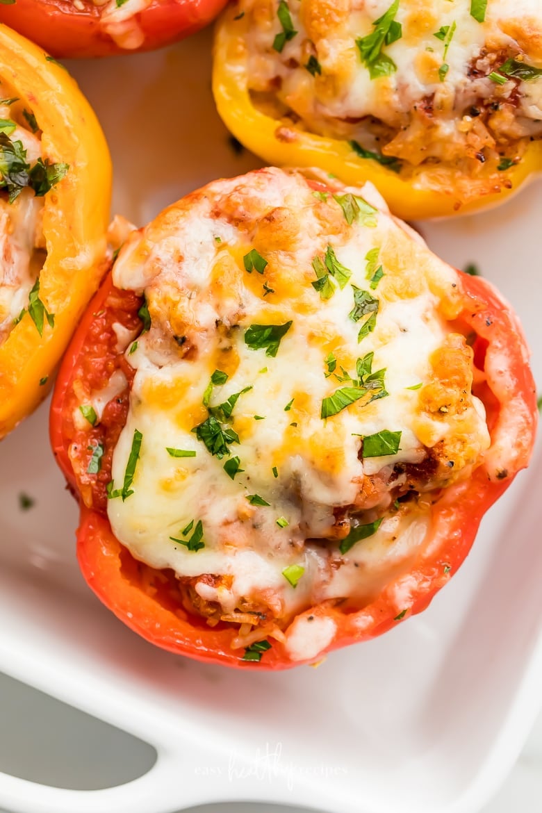 Bell peppers stuffed with turkey and rice, topped with melted cheese.