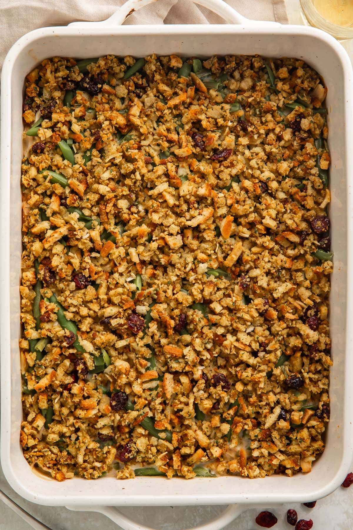 Overhead view of a creamy chicken and stuffing casserole in a large white baking dish.