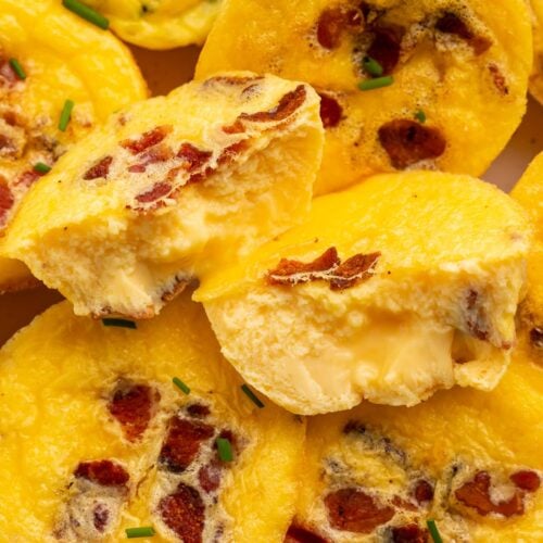 Close up of muffin-shaped egg bites made with cottage cheese, chopped bacon, and other mix-ins.