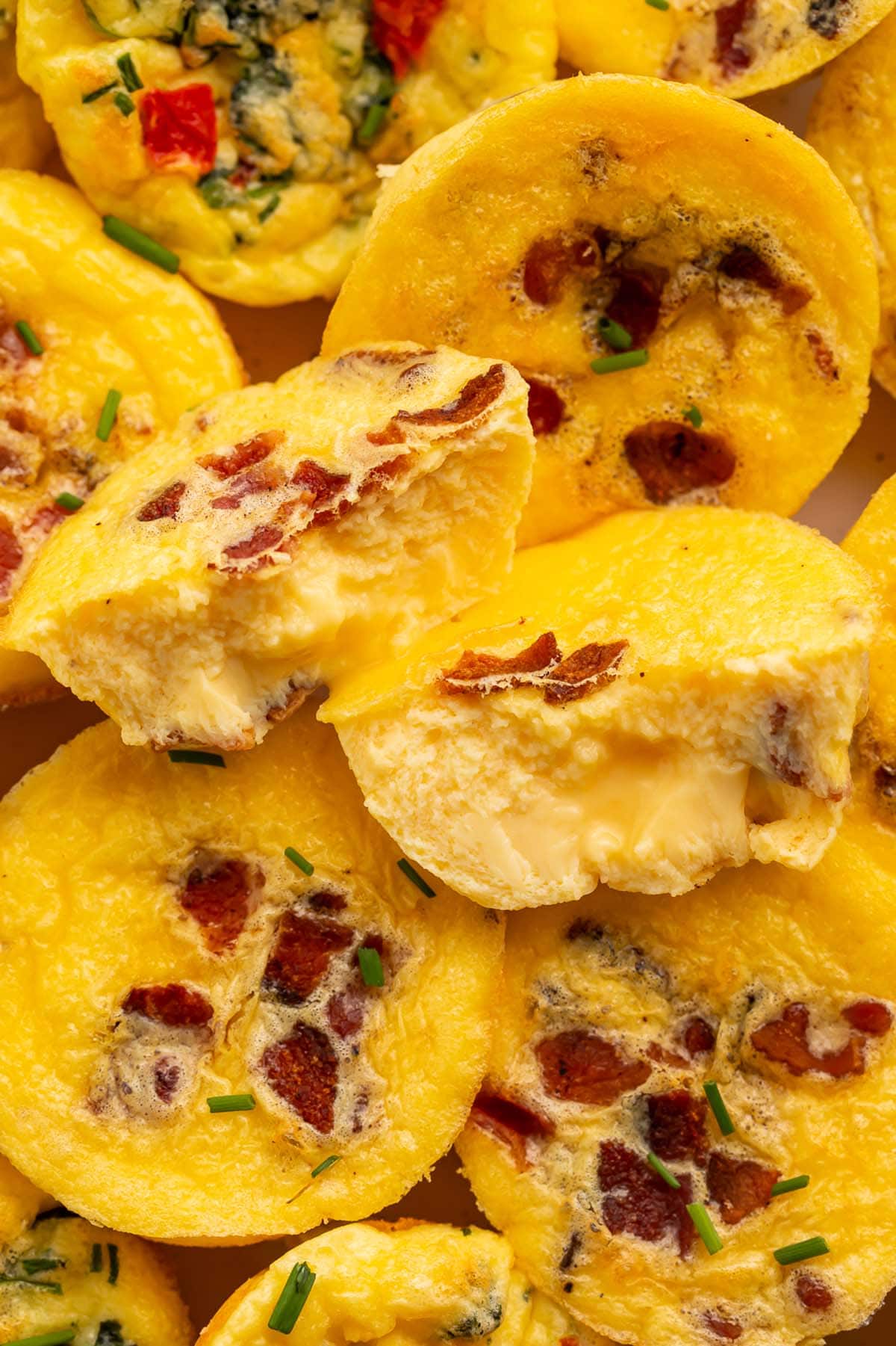 Close up of muffin-shaped egg bites made with cottage cheese, chopped bacon, and other mix-ins.