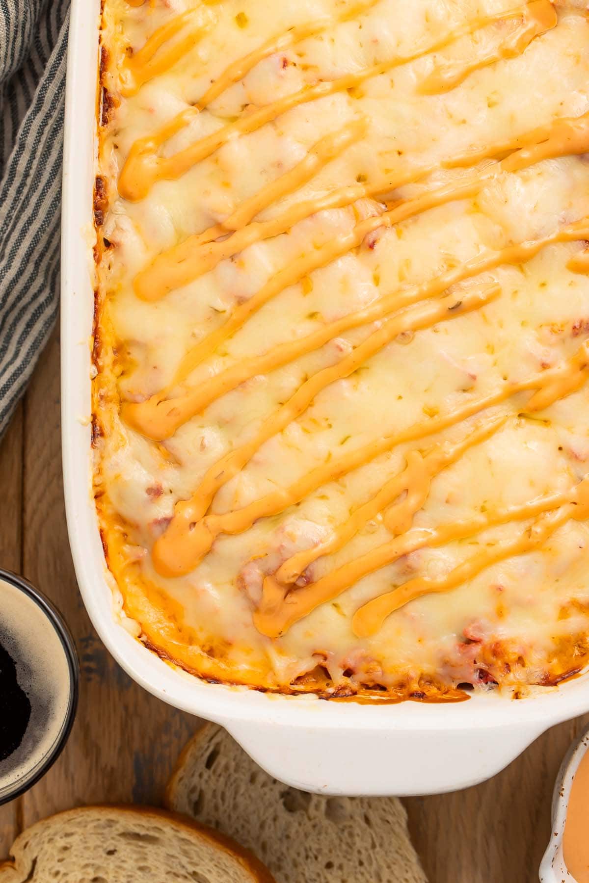 A close-up of the corner of a reuben casserole in a casserole dish.