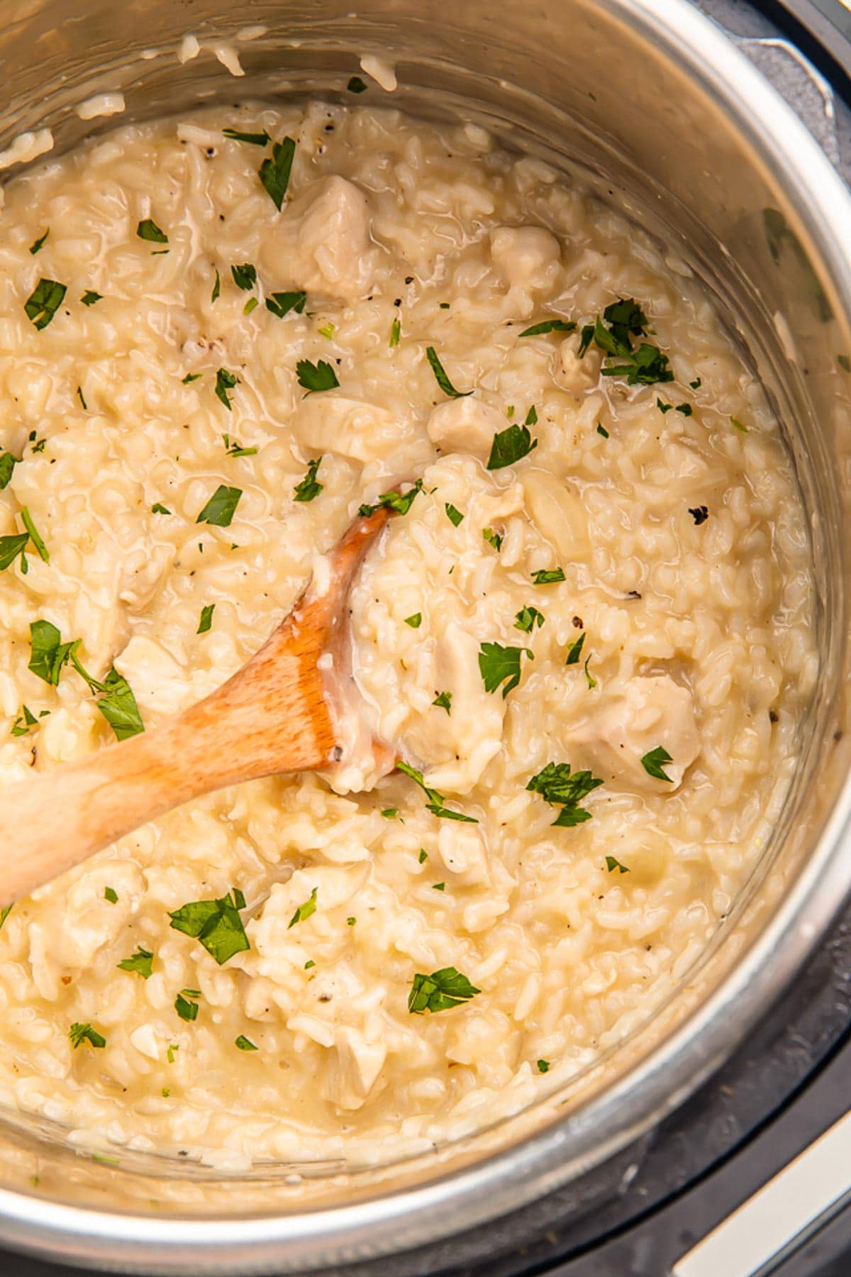 A close-up of creamy Instant Pot chicken and rice in an Instant Pot.