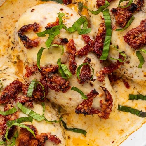 Close-up of creamy marry me chicken casserole in a casserole dish.