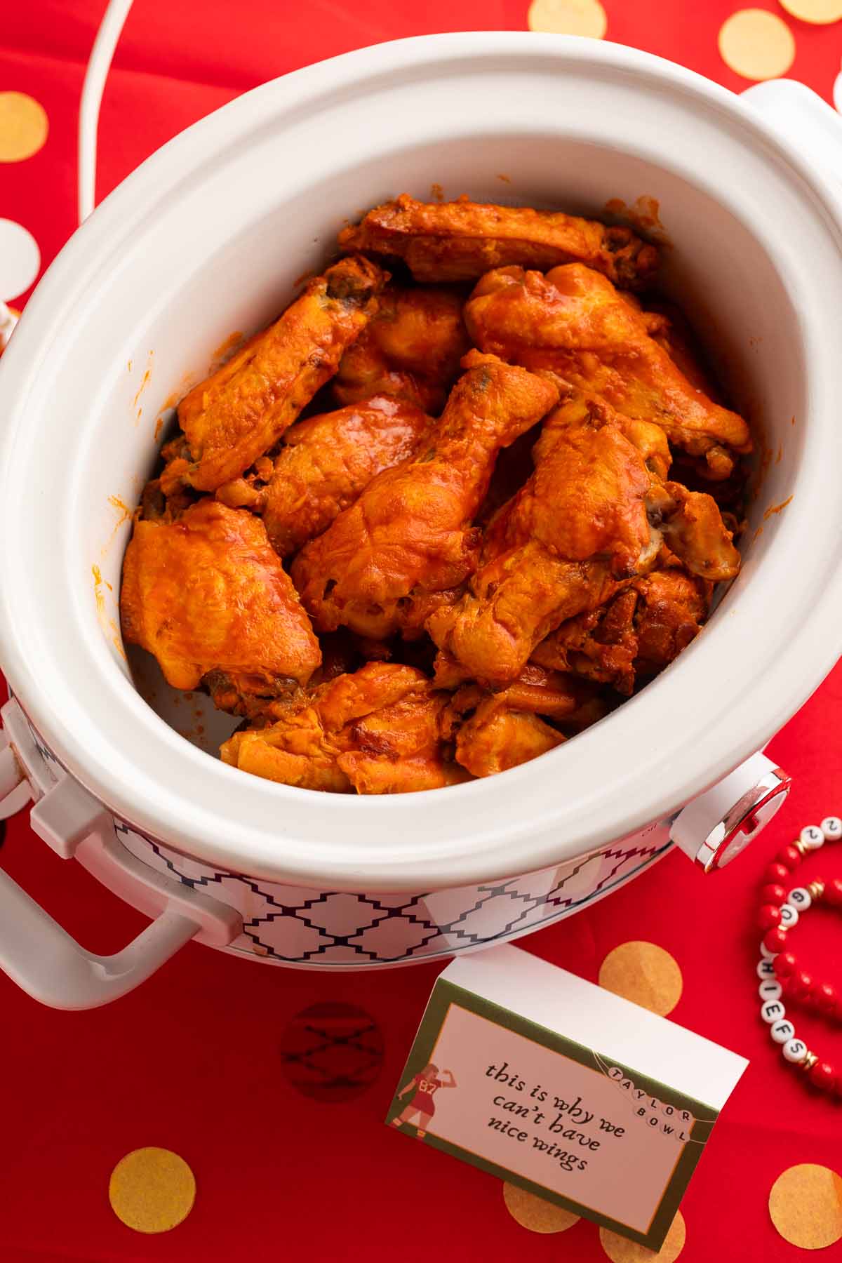 Crockpot chicken wings in a Crockpot on a table.