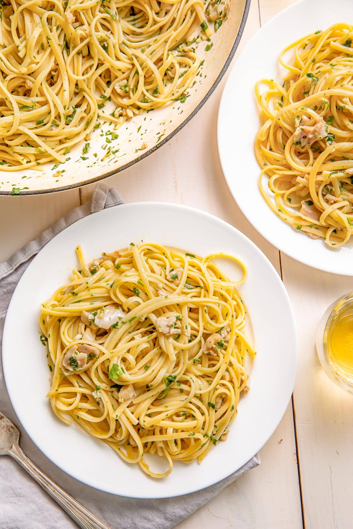 A plate of linguine tossed with white clam sauce and fresh herbs.