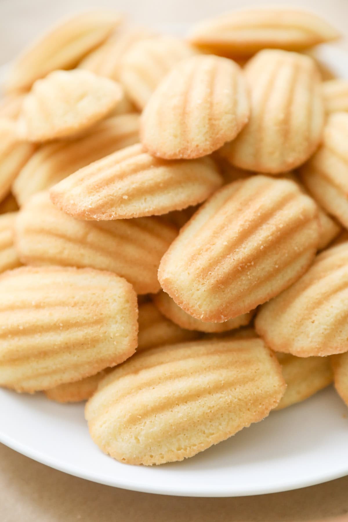 Soft Madeleine cookies from Costco arranged on a white platter.