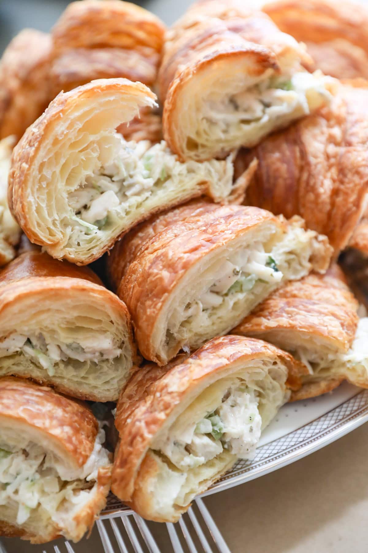 Croissants stuffed with Costco chicken salad, arranged on a platter.