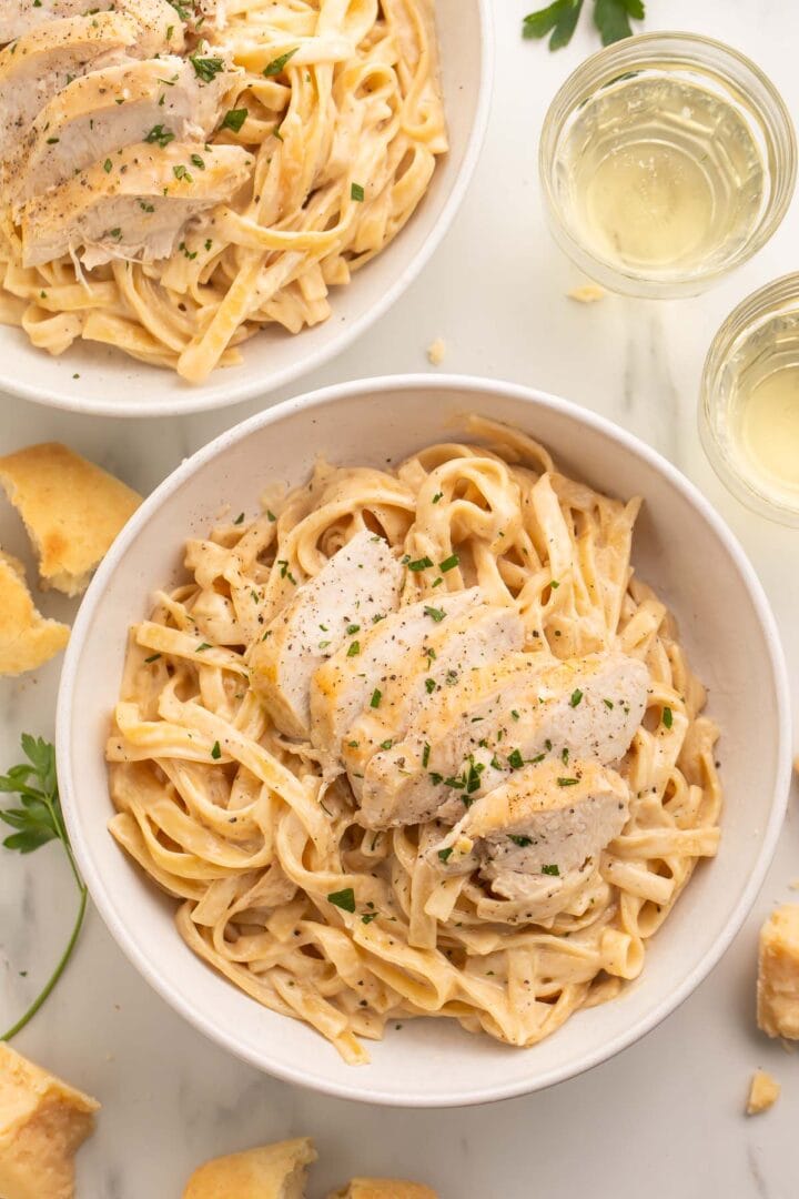 Overhead photo of a large white bowl holding chicken alfredo cooked in an Instant Pot.