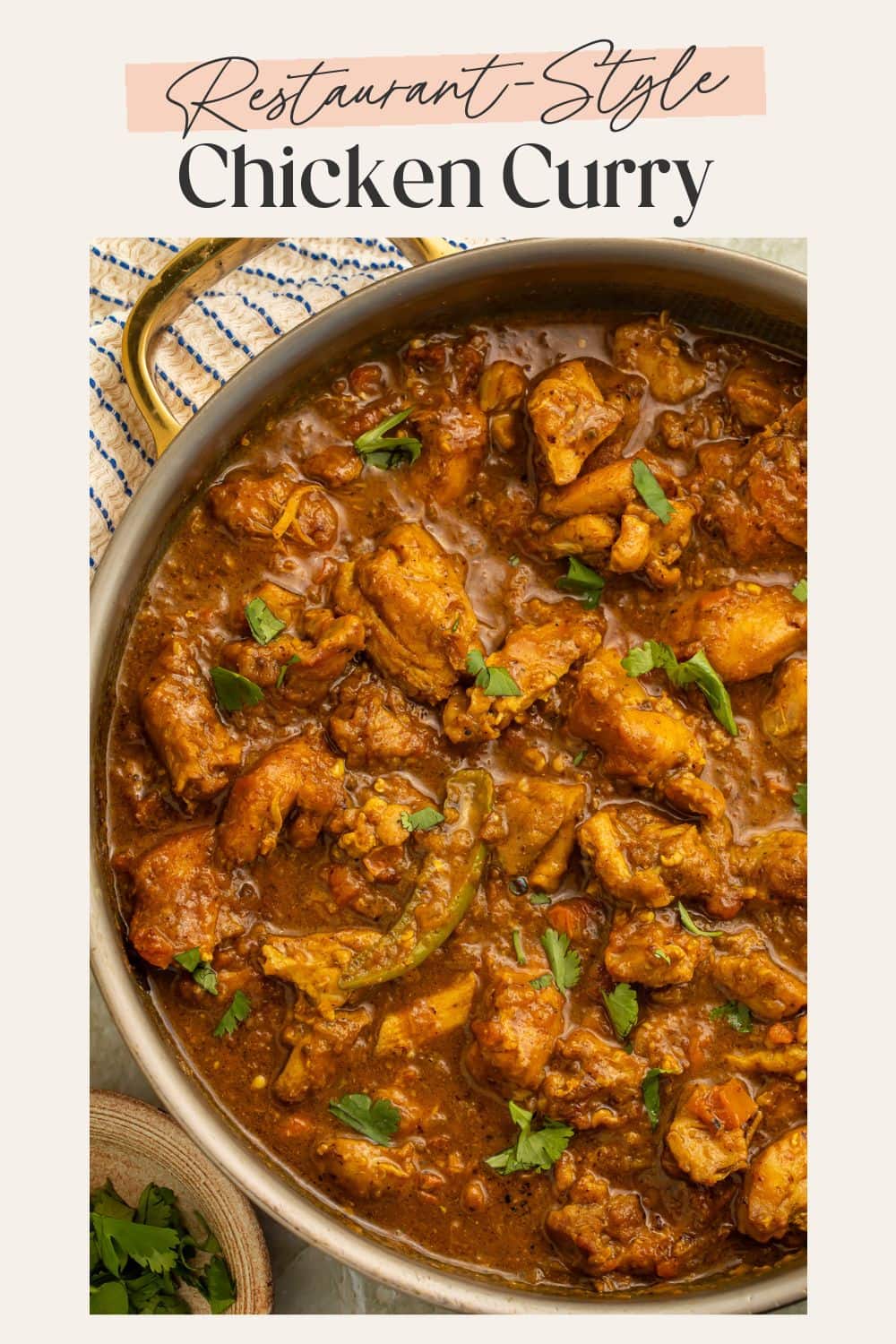Restaurant-style chicken curry simmering in a gold pan with cilantro garnish