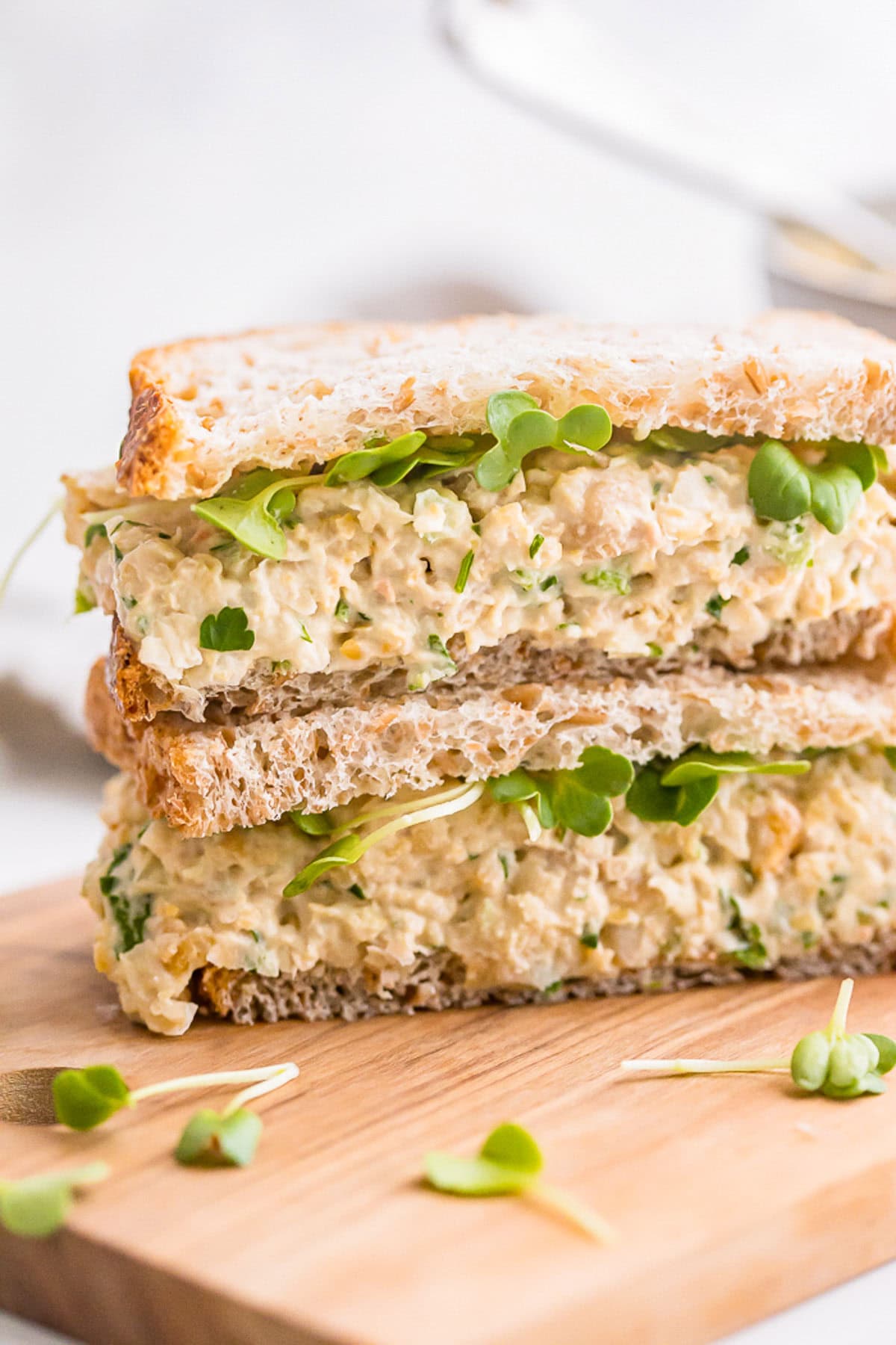 Chickpea salad sandwich on a wooden board.