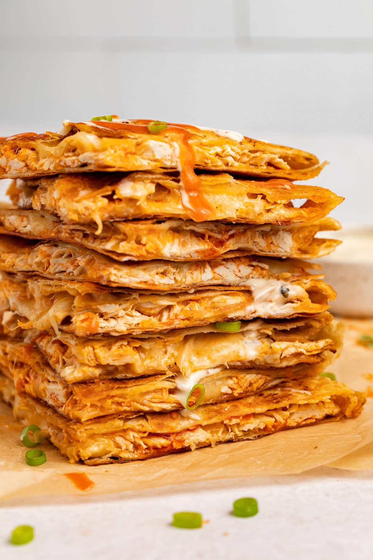 A stack of buffalo chicken quesadilla triangles.