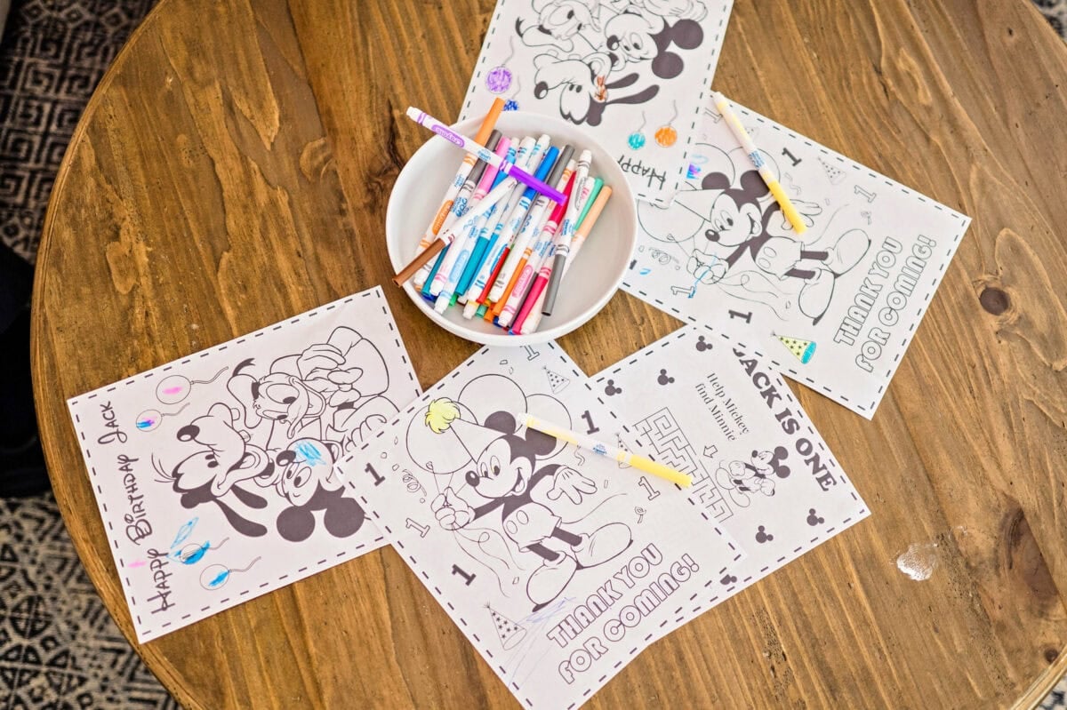 Coloring pages and crayons spread across a coffee table.