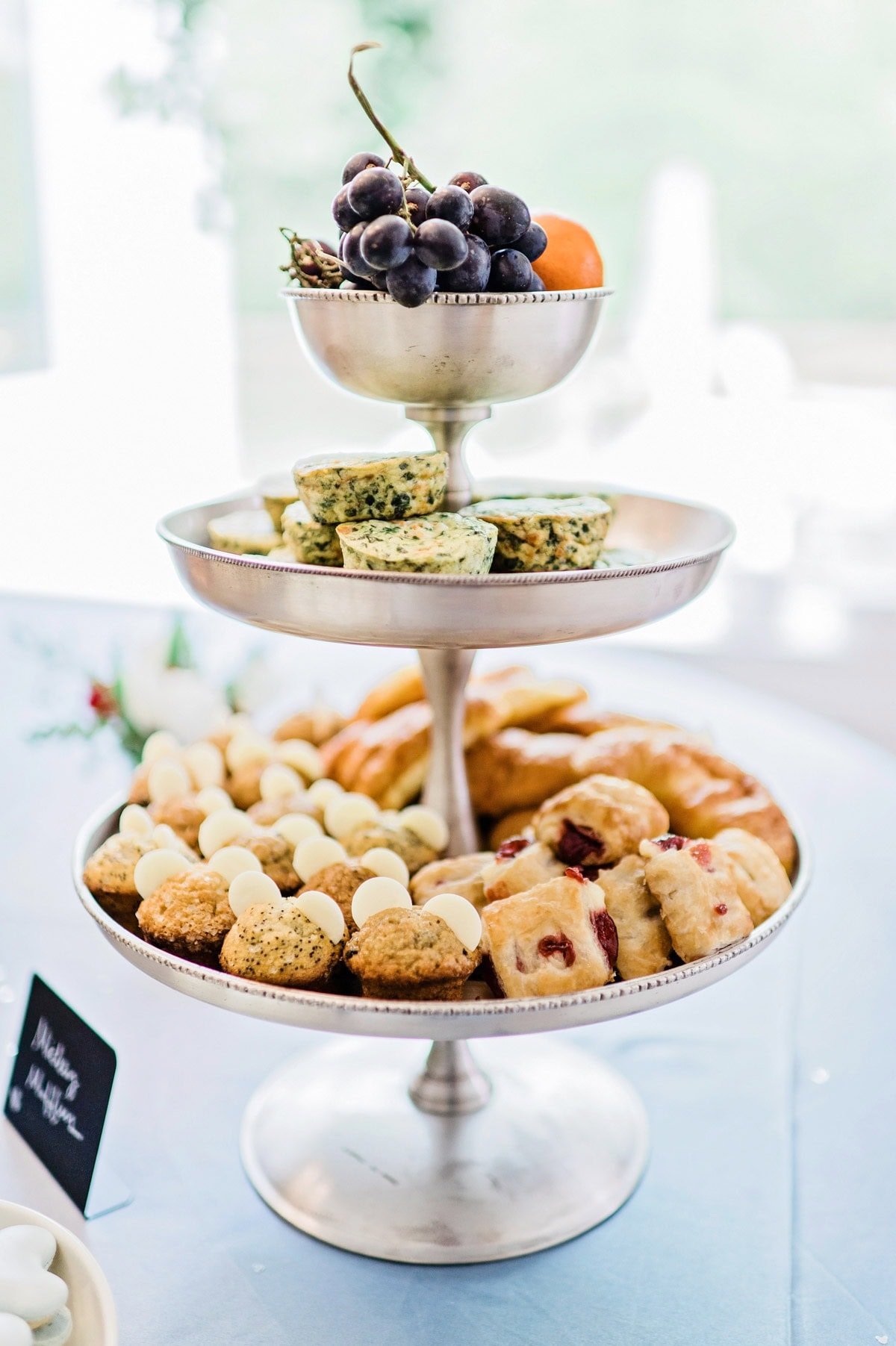 Brunch foods on platters and tiered trays for a Magic Kingdom birthday party.