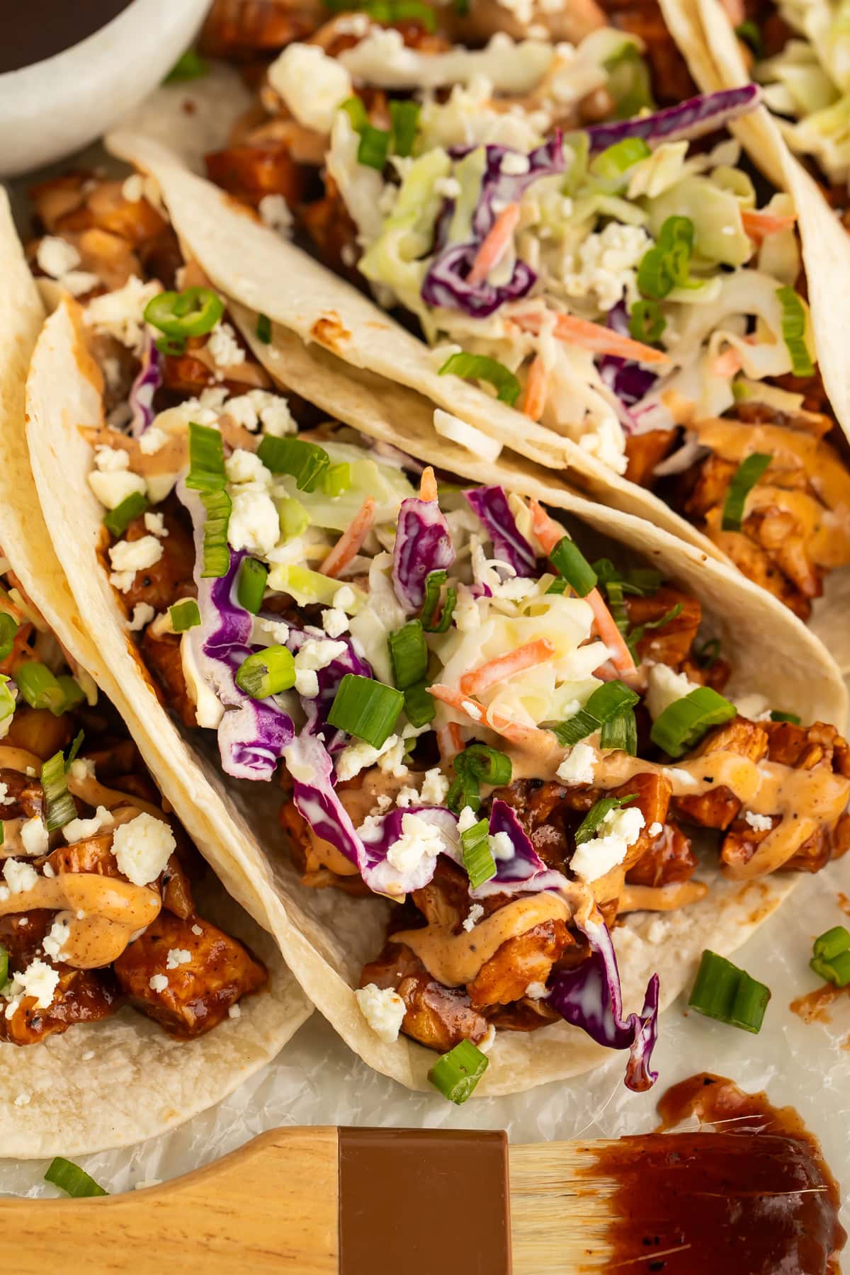 Close-up of BBQ chicken tacos arranged on a platter.