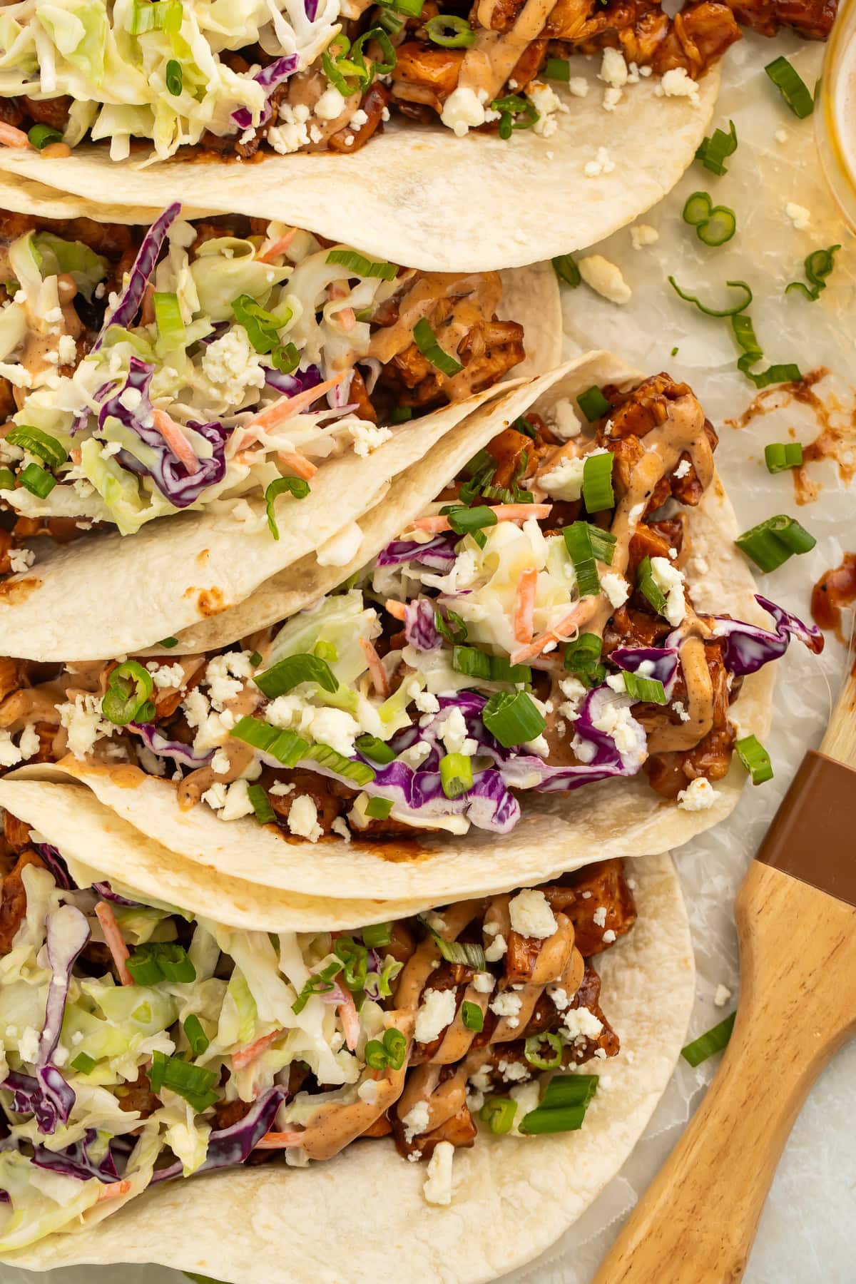 Close-up of BBQ chicken tacos arranged on a platter.