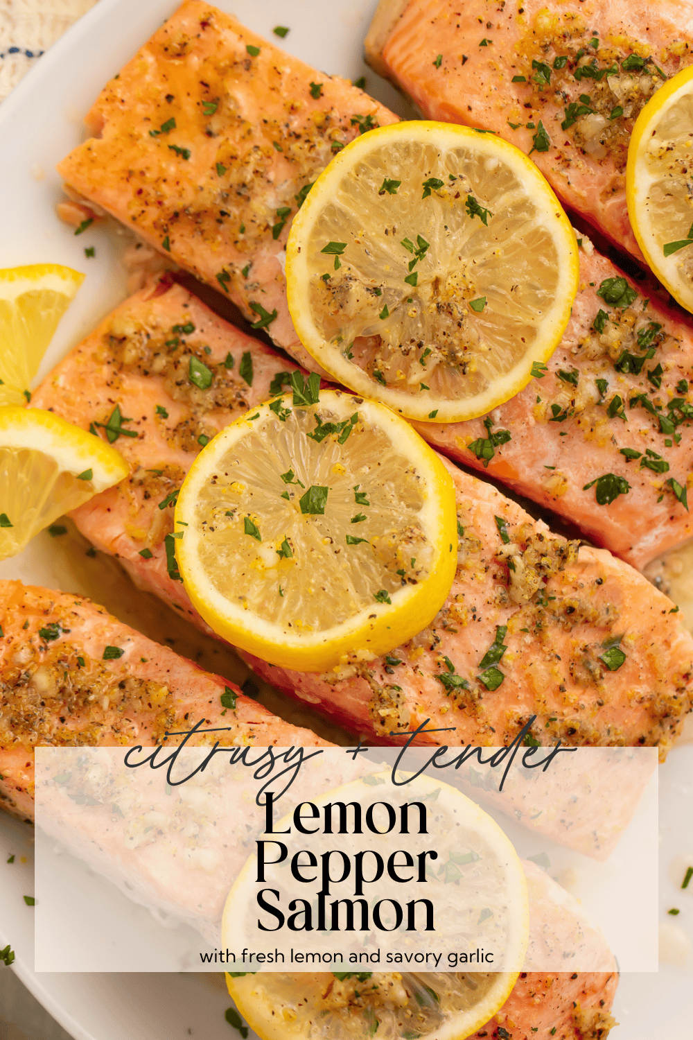 Overhead view of lemon pepper salmon in baking dish with cooking juices and fresh