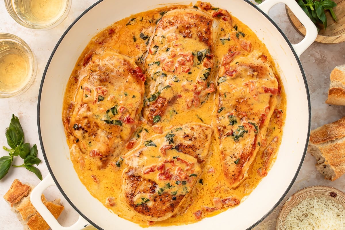 Marry me chicken with parmesan cream sauce and sun-dried tomatoes in cast iron pot