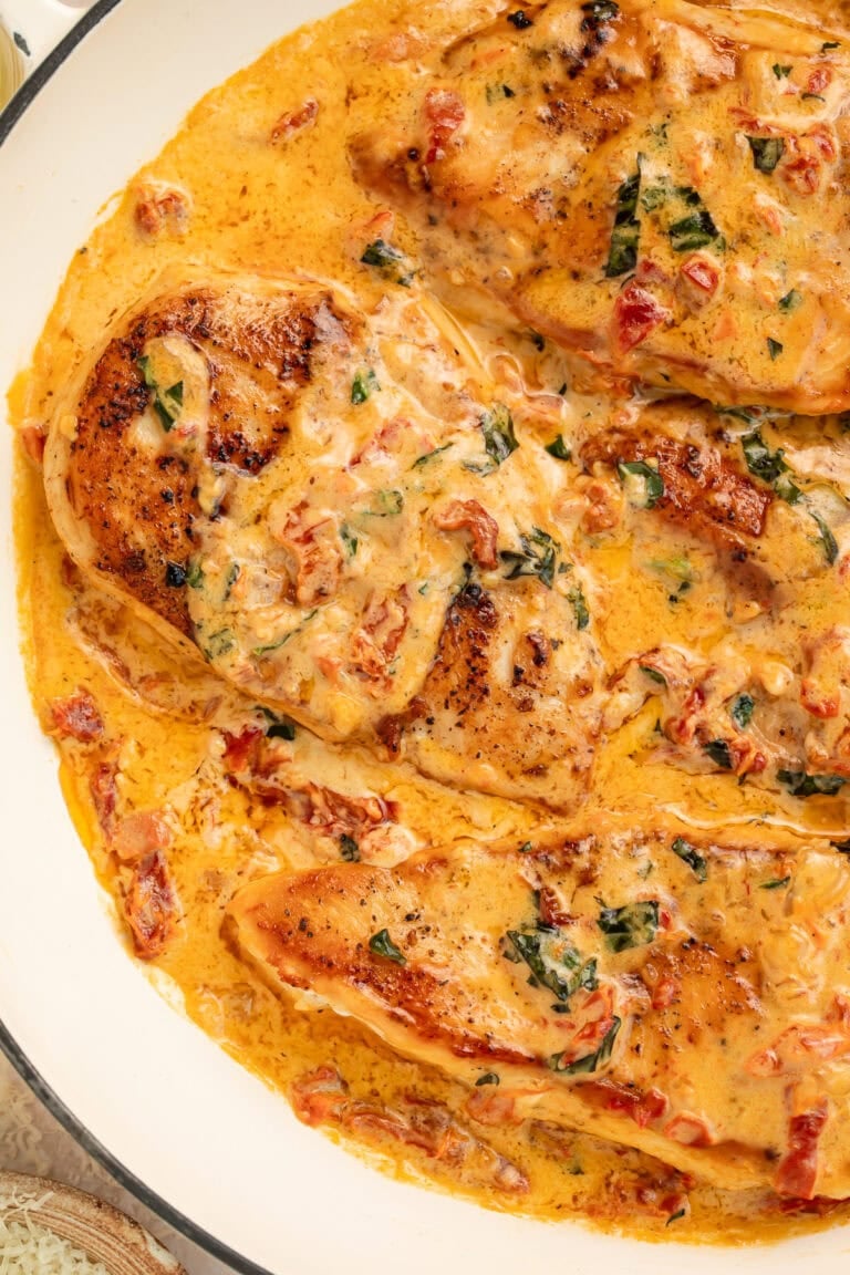 Marry me chicken with parmesan cream sauce and sun-dried tomatoes in cast iron pot