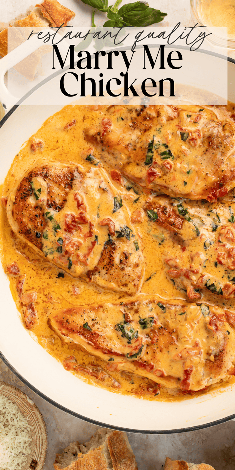 Close-up of juicy chicken breast covered in rich cream sauce with fresh basil garnish