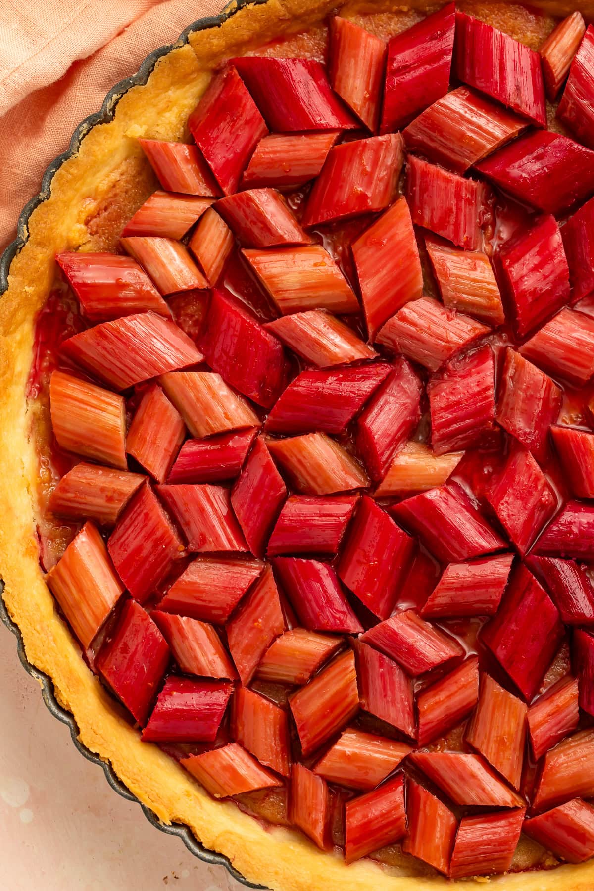 Homemade rhubarb tart with frangipane filling and glazed rhubarb topping