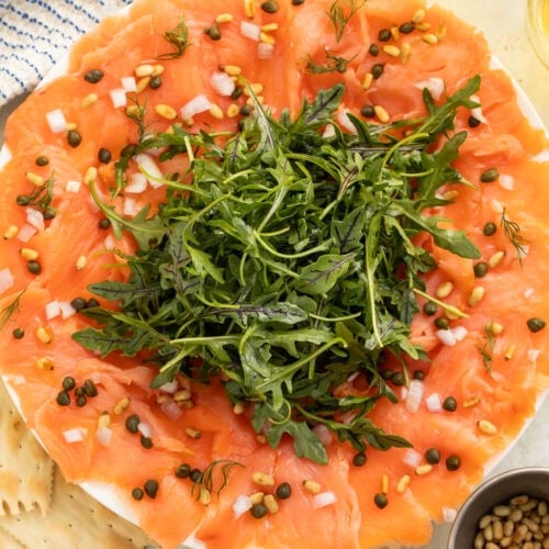 Brown butter ponzu salmon carpaccio with sliced jalapeños and glossy sauce