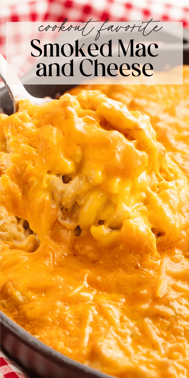 Creamy smoked mac and cheese in a cast iron skillet with a spoon lifting a portion showing the melted cheese texture