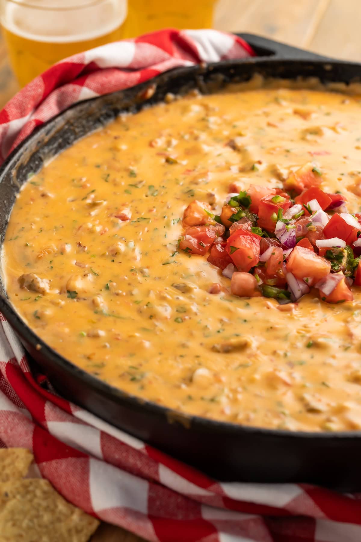 Ingredients for smoked queso recipe including cubed cheese, browned sausage, Rotel tomatoes, and seasonings