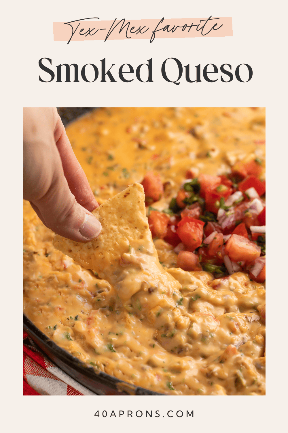 Creamy smoked queso dip with melted cheese and sausage in a cast iron skillet, garnished with fresh cilantro