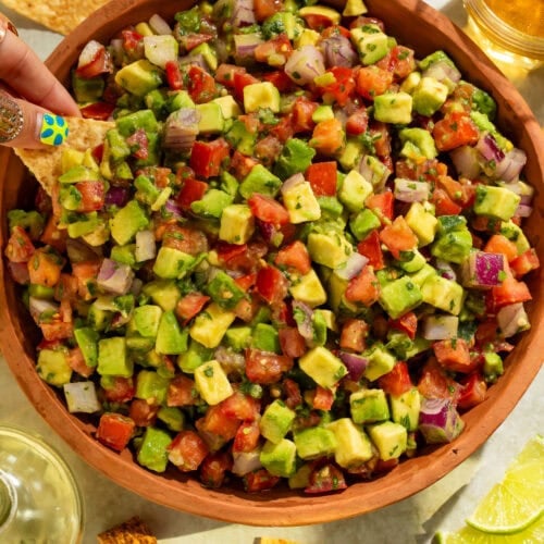 Close-up overhead view of fresh avocado tomato salsa showing colorful diced vegetables