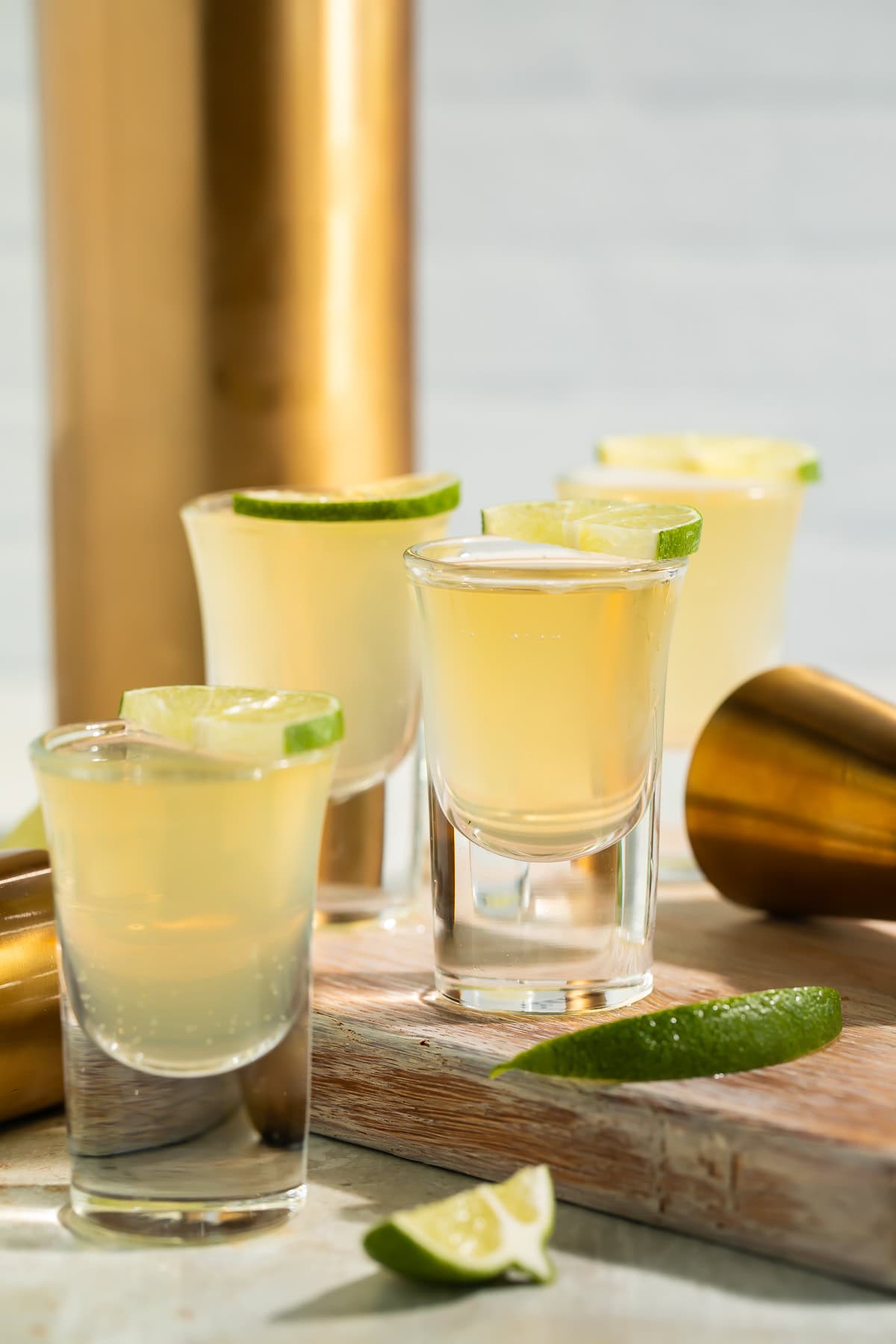 Green tea shot in clear shot glass with pale green color on wooden bar surface
