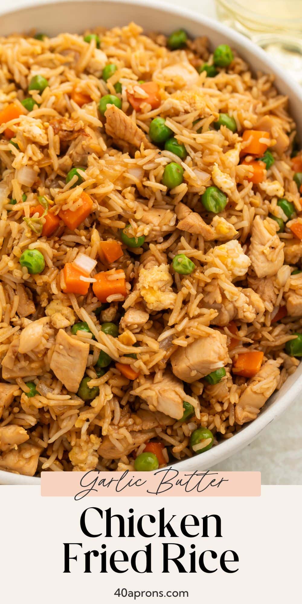 Garlic butter chicken fried rice in white bowl with recipe title at bottom