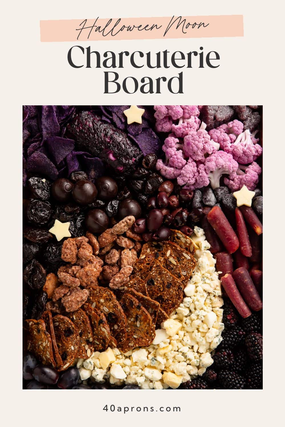 Halloween moon charcuterie board pin with purple and black foods and star cheese cutouts on beige background