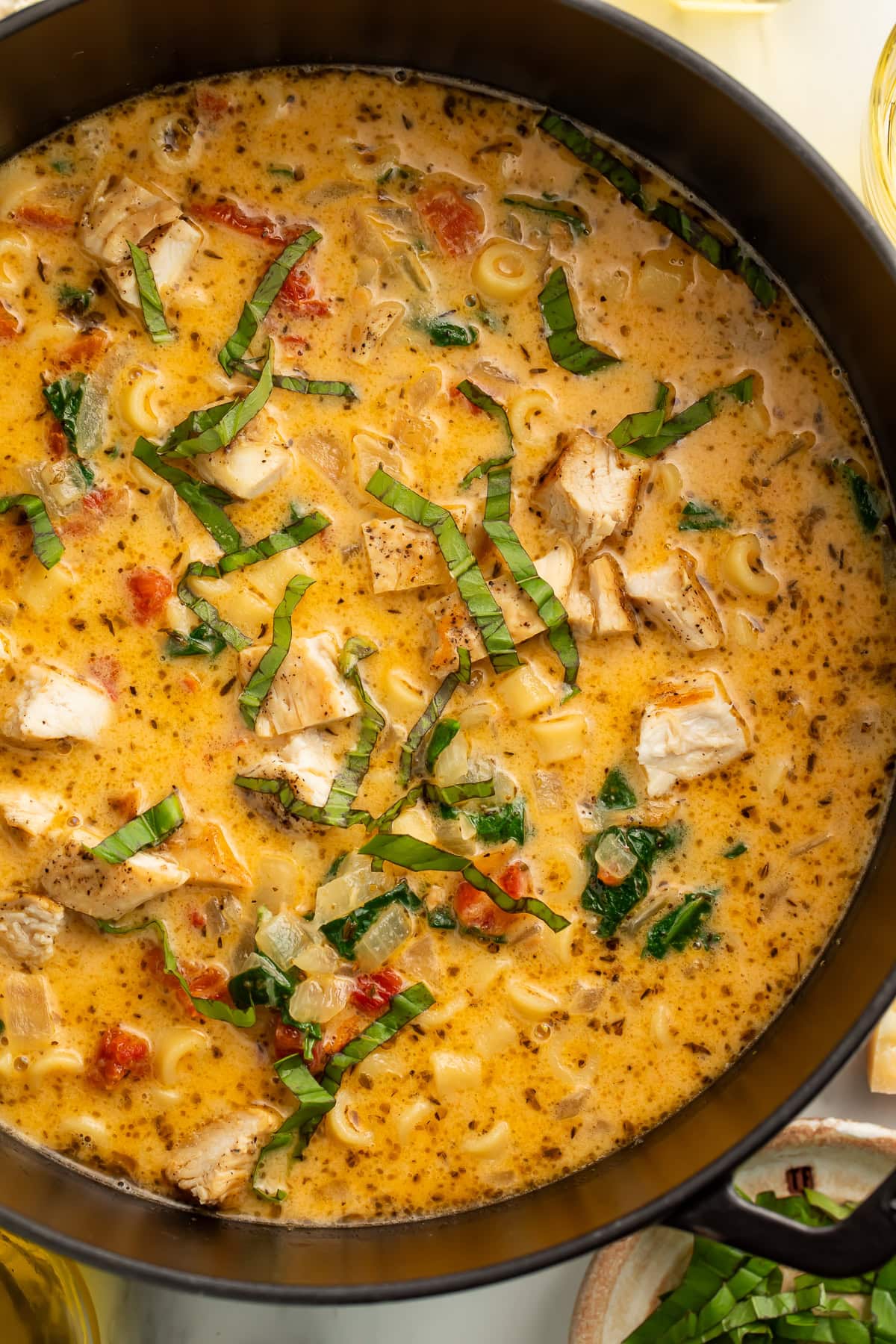 Marry Me Chicken Soup in a large Dutch oven showing the full one-pot recipe with pasta, chicken, spinach, and creamy Parmesan broth topped with fresh basil