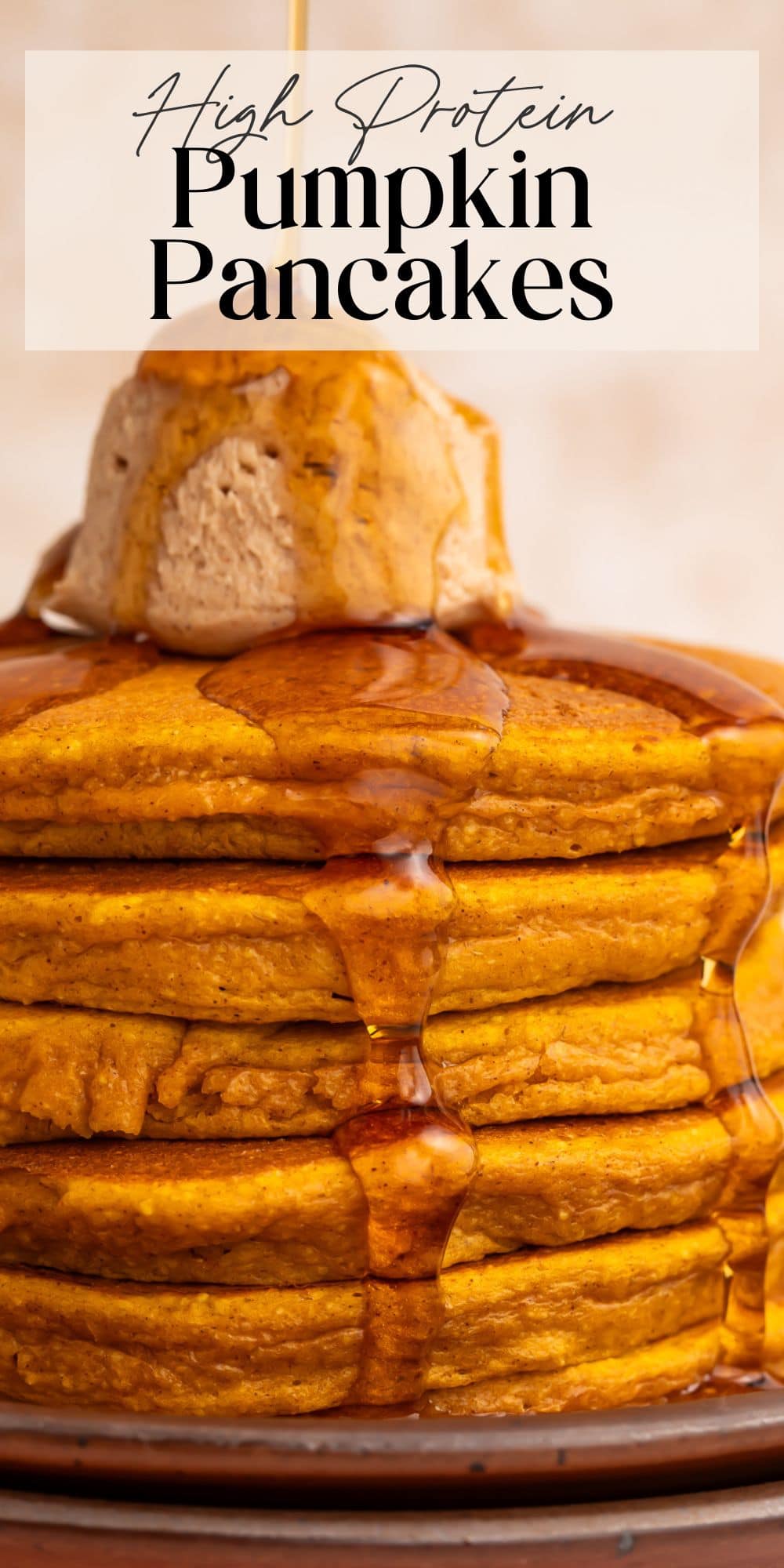 Tall stack of fluffy pumpkin protein pancakes with maple syrup dripping down sides