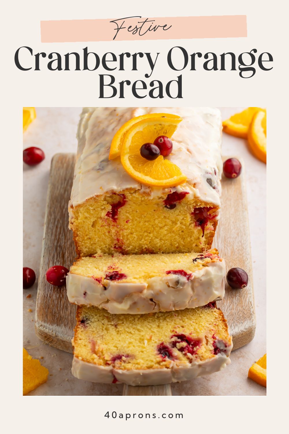 Festive cranberry orange bread sliced on wooden board with white glaze and fresh cranberries