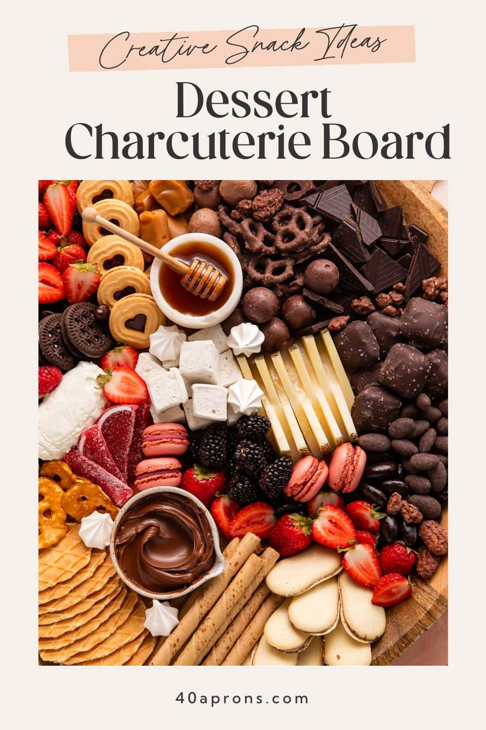 Dessert grazing board with sweet snack ideas including chocolate covered pretzels waffle cookies fresh fruit cheese honey and assorted treats.