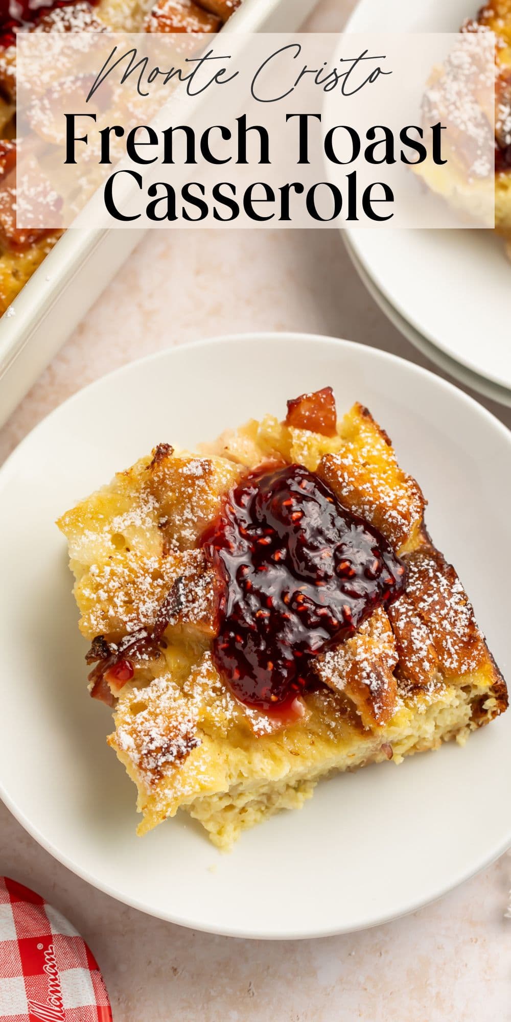 Monte Cristo French toast casserole slice topped with raspberry jam and dusted with powdered sugar
