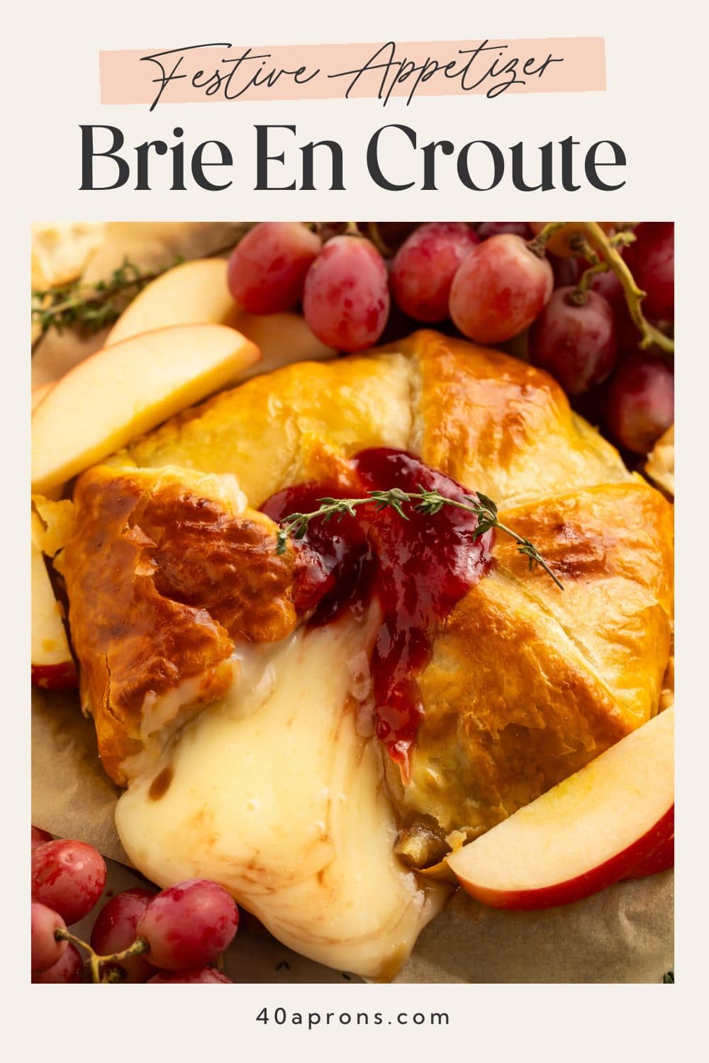Festive appetizer brie en croute Pinterest pin with golden pastry and oozing melted cheese.