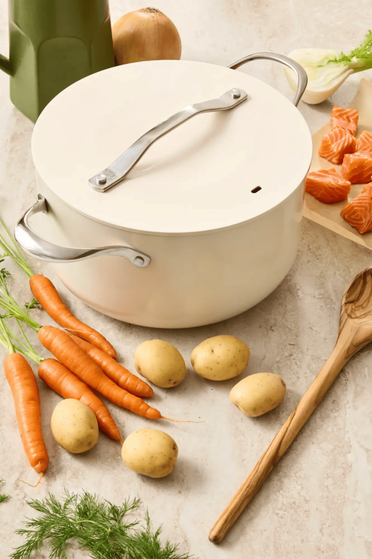 Quince ivory ceramic nonstick soup pot with lid on marble counter