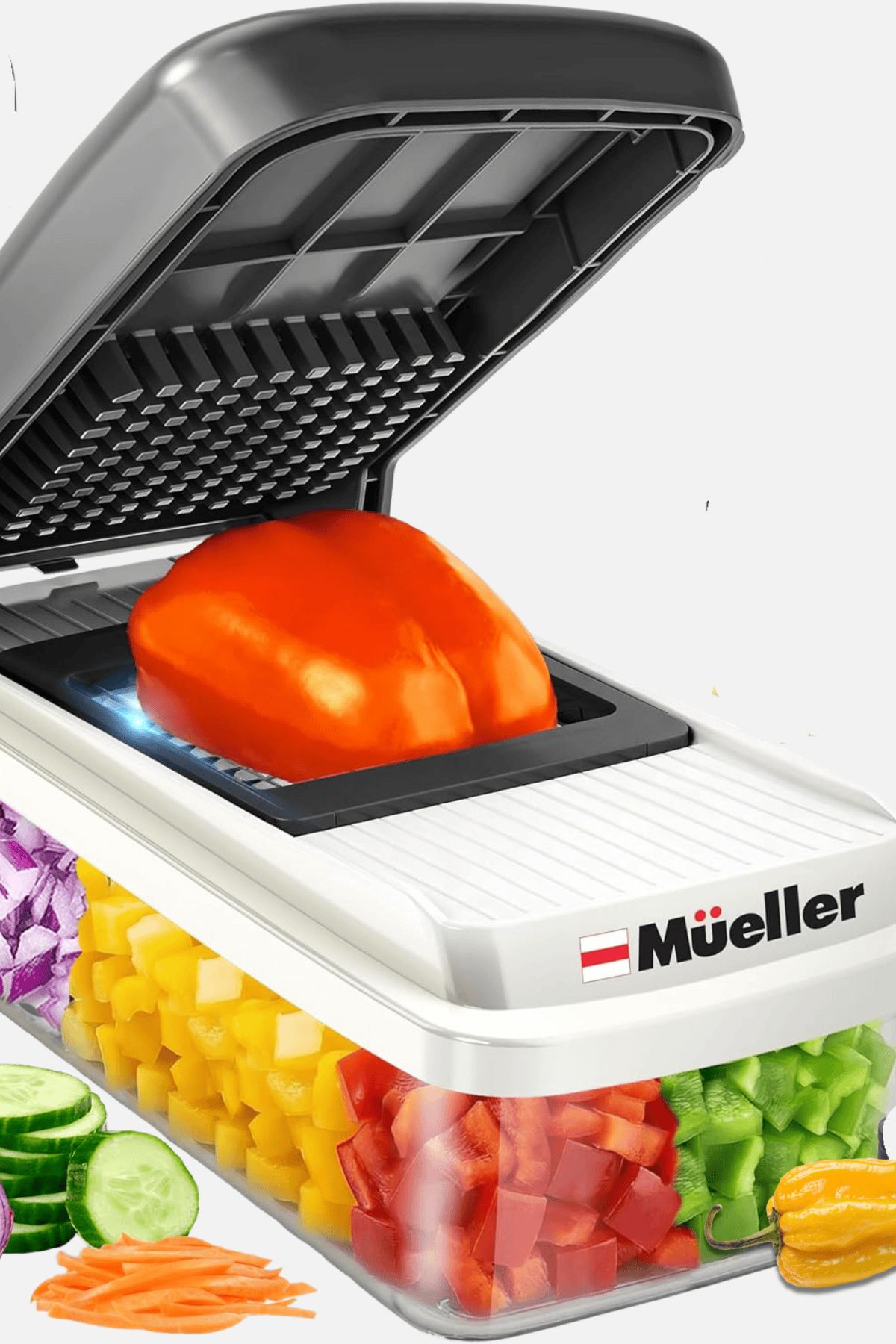 Mueller vegetable chopper dicing red bell pepper with rainbow of chopped vegetables