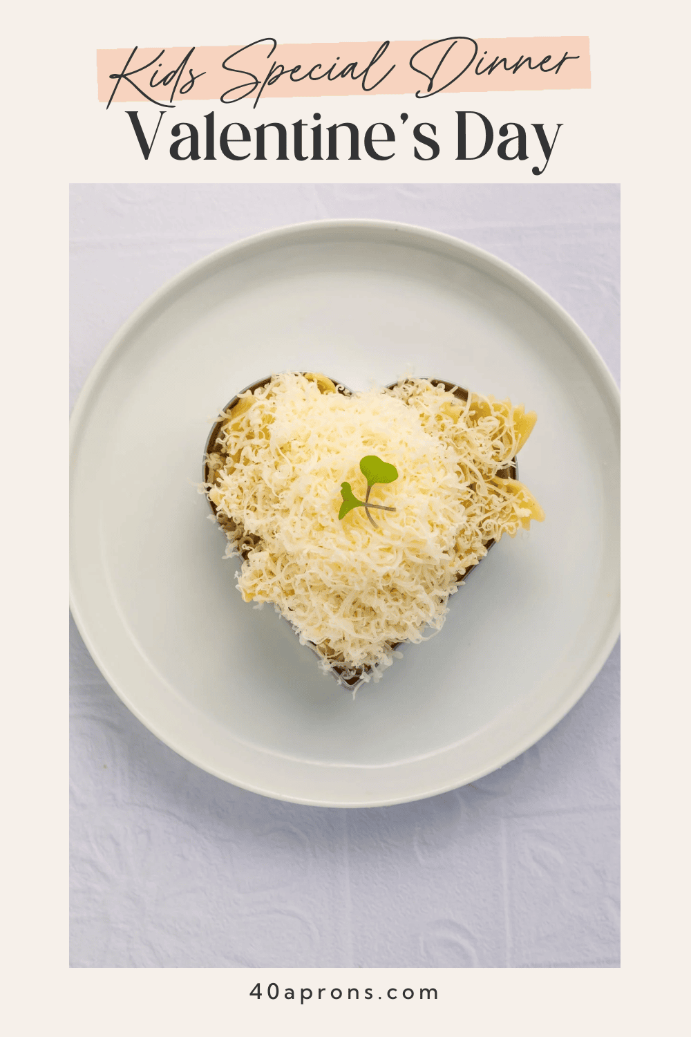 Pinterest pin for kids special Valentine's dinner showing heart-shaped bow tie pasta covered in grated Parmesan cheese with micro-green garnish