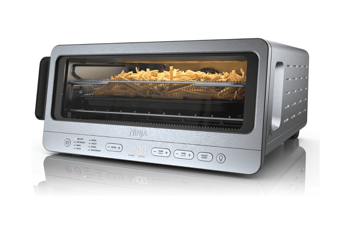 Silver Ninja air fryer toaster oven with french fries cooking on wire rack
