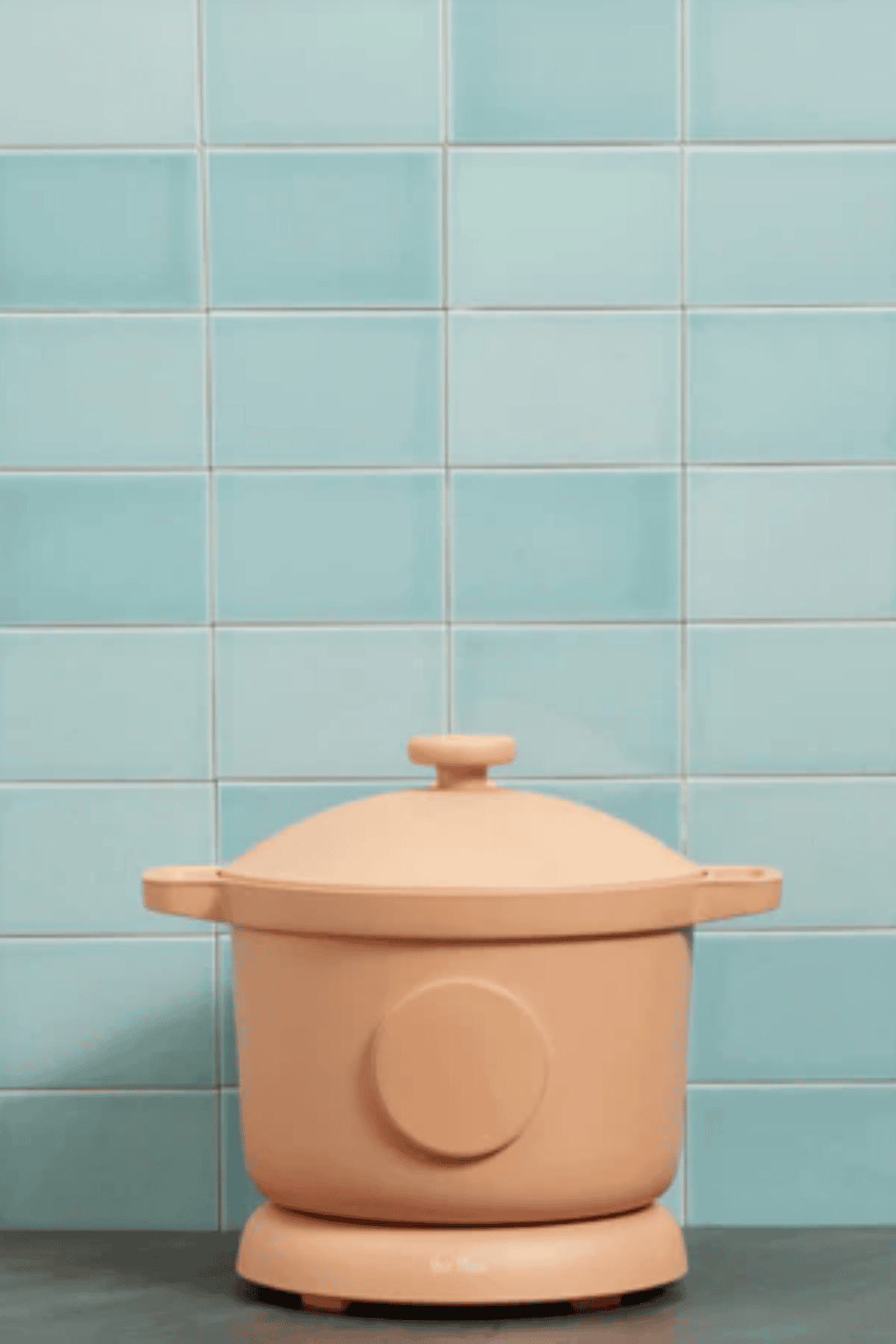 Our Place Dream Cooker in peach displayed in front of a light blue tile background